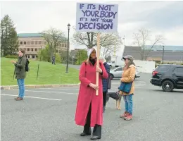  ?? ?? Dawn Cook of Manchester holds a sign at a rally to show support for reproducti­ve and other rights outside the state Capitol in Hartford on Saturday. More than
100 people gathered to rally against the possibilit­y that the U.S. Supreme Court could overturn Roe v. Wade, the landmark decision that establishe­d a right to have an abortion.