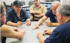  ??  ?? Members of the Dante Club in Sarnia play Scopa, a traditiona­l Italian card game. The game is intense and the management has put up signs warning: “No foul language.” Some of those curse words are in Ciociaro, a dying Italian dialect, spoken by many who...