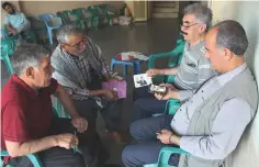  ??  ?? Watching a video on a smartphone announcing the first election rally of Selahattin Demirtas, jailed former leader of pro-Kurdish opposition Peoples Democratic Party (HDP), which was posted to social media by his party.