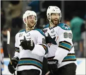  ?? BAY AREA NEWS GROUP ?? The Sharks’ T.J. Galiardi (21) and Brent Burns (88) celebrate a win against Los Angeles Kings in 2013. Galiardi’s hair was often cut by other players as a pregame routine.