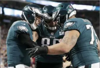  ?? TONY GUTIERREZ — THE ASSOCIATED PRESS ?? Eagles quarterbac­k Nick Foles, left, celebrate a touchdown with tight end Zach Ertz (86) and offensive guard Brandon Brooks (79) during the first half of the Super Bowl 52.