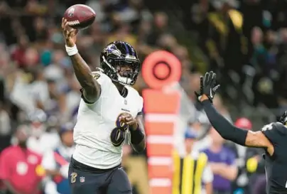  ?? GERALD HERBERT/AP ?? Ravens quarterbac­k Lamar Jackson throws under pressure from Saints safety Chris Harris Jr. during a game in New Orleans on Nov. 7.