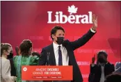  ?? PAUL CHIASSON — THE CANADIAN PRESS ?? Liberal Leader Justin Trudeau greets supporters prior to his victory speech at party campaign headquarte­rs in Montreal early Tuesday.