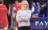  ?? Orlin Wagner / Associated Press ?? Kansas strength coach Andrea Hudy stands on court while Kansas players warm up for a game against Cornell in Lawrence, Kan., in 2010.