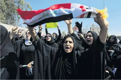  ?? PHOTO: REUTERS ?? Anger . . . Iraqi women shout slogans during a protest about neglect of their city’s collapsing infrastruc­ture in Basra, Iraq yesterday.