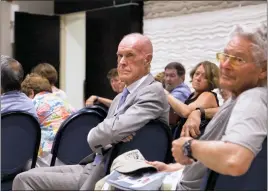  ?? STAFF PHOTO BY DANDAN ZOU ?? Former state senator Bernie Fowler, middle, of Prince Frederick and others listen as retired physician John Roache of Mechanicsv­ille, not pictured, speaks Friday evening at a lecture given by Rita Colwell, a professor from the University of Maryland...