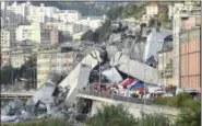  ?? LUCA ZENNARO — ANSA VIA AP ?? Rescuers work to recover an injured person after the Morandi highway bridge collapsed in Genoa, northern Italy, Tuesday. The highway bridge collapsed during a violent storm, sending vehicles plunging 45 meters (nearly 150 feet) into a heap of rubble. Authoritie­s said at least 20 people were killed, although some people were found alive in the debris.