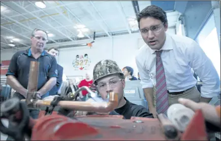  ?? JONATHAN HAYWARD/CANADIAN PRESS ?? Liberal Leader Justin Trudeau tours a pipe fitting training facility during a campaign stop in Waterloo, Ont., on Tuesday.