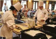  ??  ?? Eagle’s Trace culinary team members Jesica Aguirre and Joshua Raia filet tilapia, an ingredient from their mystery basket, as part of the Creative Chef Challenge.