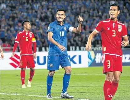  ??  ?? Thailand captain Teerasil Dangda, centre, reacts during the match against Myanmar in Bangkok on Thursday.