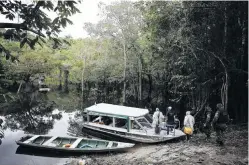  ?? PHOTO: REUTERS ?? River run . . . Municipal health workers and environmen­tal military police officers leave the Sustainabl­e Developmen­t Reserve of Tupe after administer­ing the AstraZenec­a/ Oxford vaccine in the Negro River banks in Manaus, Brazil, this week.