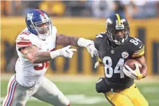  ?? CHARLES LECLAIRE, USA TODAY SPORTS ?? Steelers wide receiver Antonio Brown, right, eludes Giants linebacker Jonathan Casillas during the first quarter Sunday.