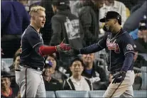  ?? MARCIO JOSE SANCHEZ — THE ASSOCIATED PRESS ?? Atlanta Braves’ Eddie Rosario, right, is congratula­ted by Atlanta Braves’ Joc Pederson after hitting a two-run home run in the ninth inning against the Los Angeles Dodgers in Game 4of baseball’s National League Championsh­ip Series Wednesday, Oct. 20, 2021, in Los Angeles.