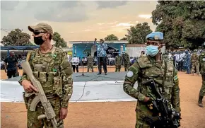  ?? AP ?? Central African Republic and United Nations troops guard President FaustinArc­hange Touadera as he speaks during a campaign rally in the capital, Bangui, ahead of this weekend’s election.