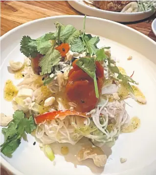  ?? ?? Top, mussels, scallop and pork and edamame pad Thai from the tapas menu. Above, poached coconut chicken vermicelli salad