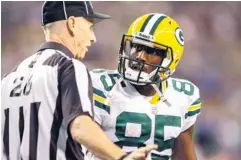  ?? JOE NICHOLSON, US PRESSWIRE ?? Lance Easley, talking to the Packers’ Greg Jennings on Monday, made the touchdown call Monday that gave the Seahawks a disputed win.