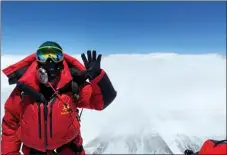  ?? SONAM DORJE / XINHUA ?? Dechen Ngodrup, head of the squad who leads the 13-member team to the summit of Mount Qomolangma, poses for a photo on May 4.