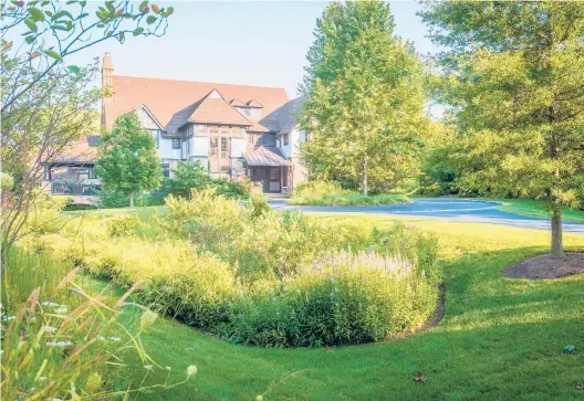  ?? ROB CARDILLO VIA THE NEW YORK TIMES ?? Stormwater can be slowed and encouraged to infiltrate with the addition of basin-shaped rain gardens like this one in Wayne, Pennsylvan­ia, created by Jonathan Alderson Landscape Architects.