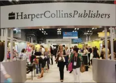  ?? AP PHOTO/MARK LENNIHAN ?? In this May 28, 2015 file photo, attendees at BookExpo America visit the HarperColl­ins Publishers booth in New York. The annual publishing convention and trade show, a decades-old tradition, may be coming to an end. ReedPop, which has managed BookExpo for a quarter century, announced Tuesday that it was dropping the event, along with the fanbased BookCon.