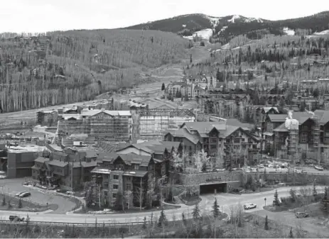  ?? Andy Cross, The Denver Post ?? Constructi­on continues on the 100-room, 11-residence Limelight Hotel (lower mid left) at the base of Snowmass Village on Oct. 29.