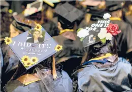  ?? BRIAN CASSELLA/CHICAGO TRIBUNE ?? Graduates with decorated mortarboar­ds May 1 in Chicago.