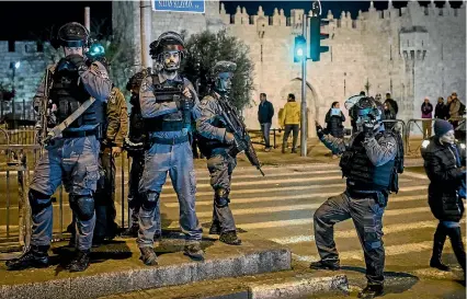  ?? PHOTO: GETTY IMAGES ?? Israeli police officers stand watch outside the Damascus Gate in the Old City in Jerusalem yesterday. Tension is high in the city after United States President Donald Trump’s announceme­nt recognisin­g Jerusalem as the capital of Israel.