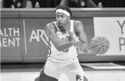  ?? MICHAEL WOODS/AP ?? Arkansas guard Moses Moody (5) makes a lookaway pass against Texas A&M on March 6.