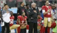  ?? MARCIO JOSE SANCHEZ — THE ASSOCIATED PRESS ?? In this Nov. 20, 2016, file photo, San Francisco 49ers quarterbac­k Colin Kaepernick (7) kneels next to outside linebacker Eli Harold (58) and safety Eric Reid, right rear, during the national anthem before an NFL football game against the New England...