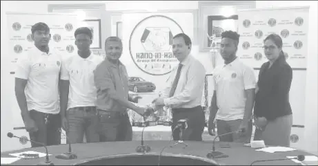 ??  ?? Honorary Secretary of the GCB, Anand Sanasie (third from left) receives the sponsorshi­p cheque from Director of Hand-In-Hand, Cecil Cox in the presence of the three West Indies Under-19 Guyanese players and Business Developmen­t Officer, Savita Singh...