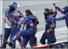  ?? MATT SLOCUM — THE ASSOCIATED PRESS ?? Crew members for Denny Hamlin celebrate Hamlin’s win in the NASCAR Cup Series auto race at Pocono Raceway, Sunday, June 28, 2020, in Long Pond, Pa.