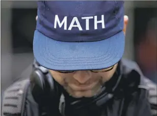  ?? Drew Angerer Getty Images ?? THE MATH hat from the Andrew Yang camp is savvy branding for the tech entreprene­ur.