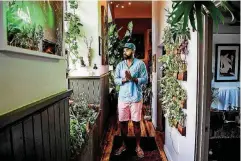  ?? [PHOTO BY SALWAN GEORGES, THE WASHINGTON POST] ?? Hilton Carter, 37, has always enjoyed plants. But his Baltimore apartment now holds 180, and it’s a perfect example of a growing trend.