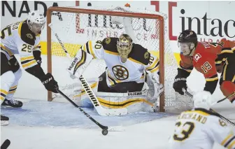  ?? AP PHOTO ?? CLOSE CALL: Defenseman Brandon Carlo knocks a loose puck away from the front of the net during the Bruins’ overtime win yesterday.