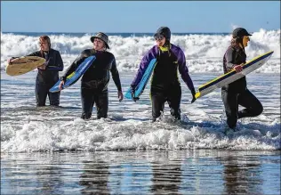  ?? JARROD VALLIERE / THE SAN DIEGO UNION-TRIBUNE/TNS ?? Members of the San Dieguito Newcomers Club’s Boogie Boarding group — Ginny Van Meter (from left), Loraine Vaught, Pam Shetler and Kim Lubesnick — gather last week to ride the surf at Solana Beach, California.