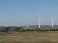  ?? WAYNE PARRY ?? This Oct. 1, 2020 photo shows windmills at a utility plant in Atlantic City N.J. On Wednesday, Nov. 18, 2020, New Jersey committed itself to building a transmissi­on system capable of handling enough offshore wind energy to power 3.2 million homes.