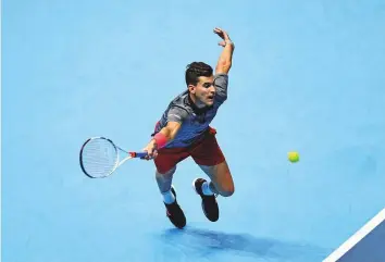  ?? Reuters ?? Dominic Thiem stretches for a forehand return against Kevin Anderson during the ATP Finals at The O2 in London on Monday.