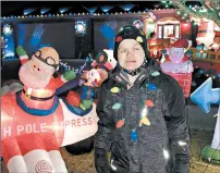  ??  ?? Dominic Steinhause­r, 12, displays his collection of Christmas inflatable­s at his family’s Frankfort home Thursday.