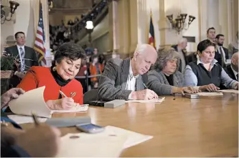  ?? NICK COTE/THE NEW YORK TIMES ?? Members of the Colorado Electoral College cast their votes for presidenti­al candidates in December 2016 in Denver.