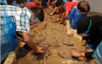  ??  ?? Young explorers dig up a dinosaur.