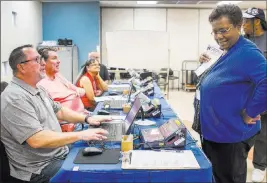  ?? Patrick Connolly ?? Las Vegas Review-journal @Pconnpie Belinda Wilson of Las Vegas, right, checks in with official representa­tive Larry Magnelli during voting for the Ward 5 Las Vegas City Council special election Tuesday at the Doolittle Community Center.