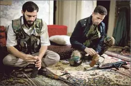  ?? JM Lopez ?? SYRIAN rebels load magazines in Aleppo. The U.S. estimates that about 65% of the rebel movement is secular and as much as 35% is made up of radical Islamists.