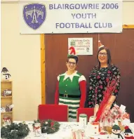  ??  ?? Good elf Parents Sarah Cannon (left) and Donna Watson at the Christmas fair in Blairgowri­e Town Hall