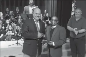  ?? The Sentinel-Record/Richard Rasmussen ?? HONORED GRADUATE: Lakeside Superinten­dent Shawn Cook, left, presents an honorary high school diploma to Lonnie L. Tidwell, a U.S. Army veteran who served in Vietnam, during a Veterans Day Ceremony at Lakeside Middle School Monday. The school honored Tidwell and Vivian Gray Erichsen with diplomas made possible by the Arkansas Department of Education Rules Governing Diplomas for Veterans.