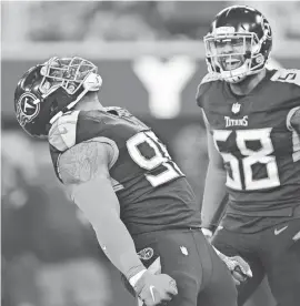  ?? GARY A. VASQUEZ/USA TODAY SPORTS ?? Titans defensive end Jeffery Simmons (98) celebrates with outside linebacker Harold Landry (58) after bringing down Rams quarterbac­k Matthew Stafford.