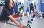  ?? FENG YONGBIN / CHINA DAILY ?? Robots developed by a research institute in Beijing are displayed at the ongoing China Beijing Internatio­nal High-Tech Expo.