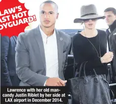  ??  ?? Lawrence with her old mancandy Justin Riblet by her side at
LAX airport in December 2014.
J. LAW’S HOT LAST BODYGUARD!