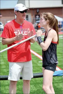  ?? TIMES photograph by Annette Beard ?? Walter Mooneyhan, left, advised daughter, Cassidy, Monday during the 4A-1 District track meet in Pea Ridge. Cassidy won the pole vault event clearing 11 feet 6 inches and will compete in the state competitio­n Tuesday, April 30, in Batesville.