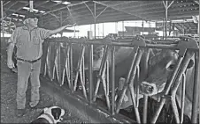  ?? PHOTO BY CHING LEE/CALIFORNIA FARM BUREAU ?? San Joaquin County dairy farmer Hank Van Exel checks on the mist that helps to cool his cows. Despite providing shade and using fans and misters to relieve their cows, California dairy farmers say they expect to lose some milk production due to...