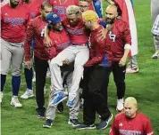  ?? Eric Espada/Getty Images ?? Edwin Díaz of Team Puerto Rico is helped off the field after being injured during the on-field celebratio­n after defeating the Dominican Republic during the World Baseball Classic at loanDepot Park on Wednesday in Miami.