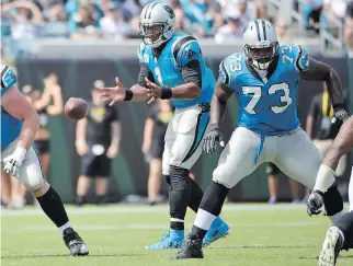  ?? THE ASSOCIATED PRESS FILES ?? Carolina Panthers offensive tackle Michael Oher, right, blocks as quarterbac­k Cam Newton takes the snap during a game in Jacksonvil­le earlier this season. Oher, the main character in the movie The Blind Side, has been protecting Newton all season.